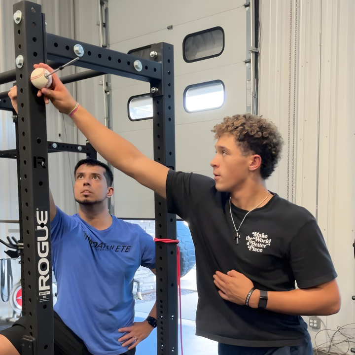 Dr. Edwin Porras working with pitcher Ethan Wachsmann