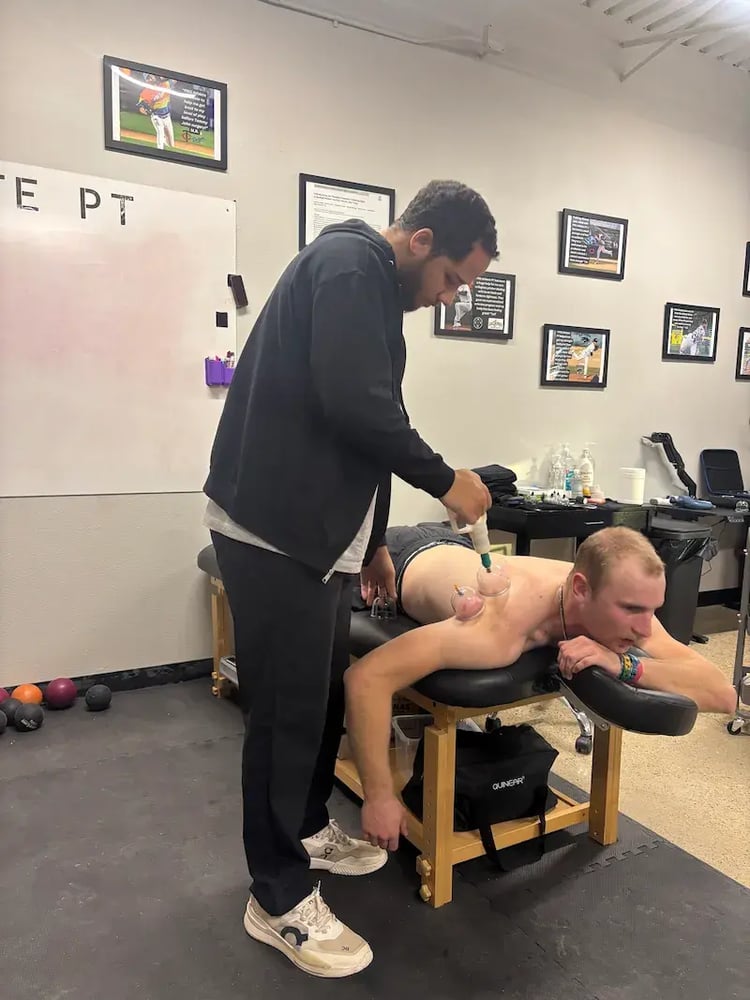 A Division II baseball player completing specialized physical therapy exercises to improve arm health.