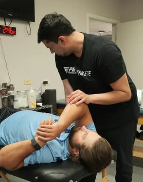 Baseball athlete working on shoulder flexibility with PRO athlete physical therapy