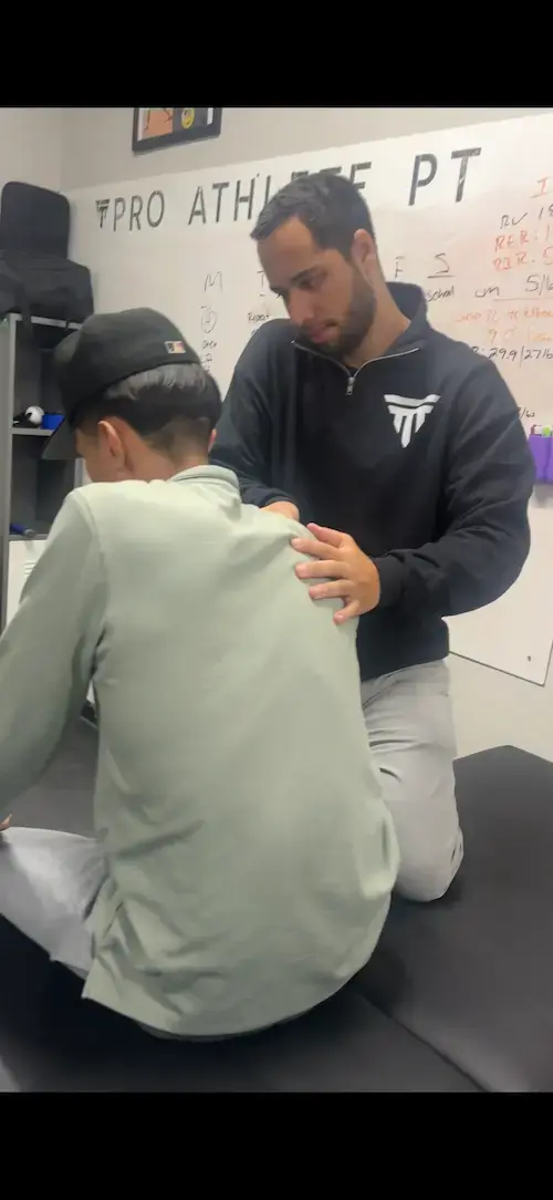 Baseball athletic trainer guiding a high school pitcher through non-surgical UCL rehab in Centennial, Colorado.